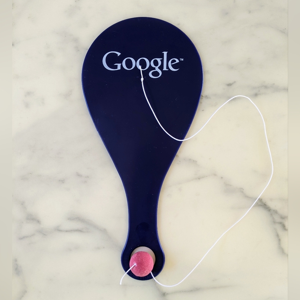 NWT. Collectible Google Navy Paddle with Pink Ball.